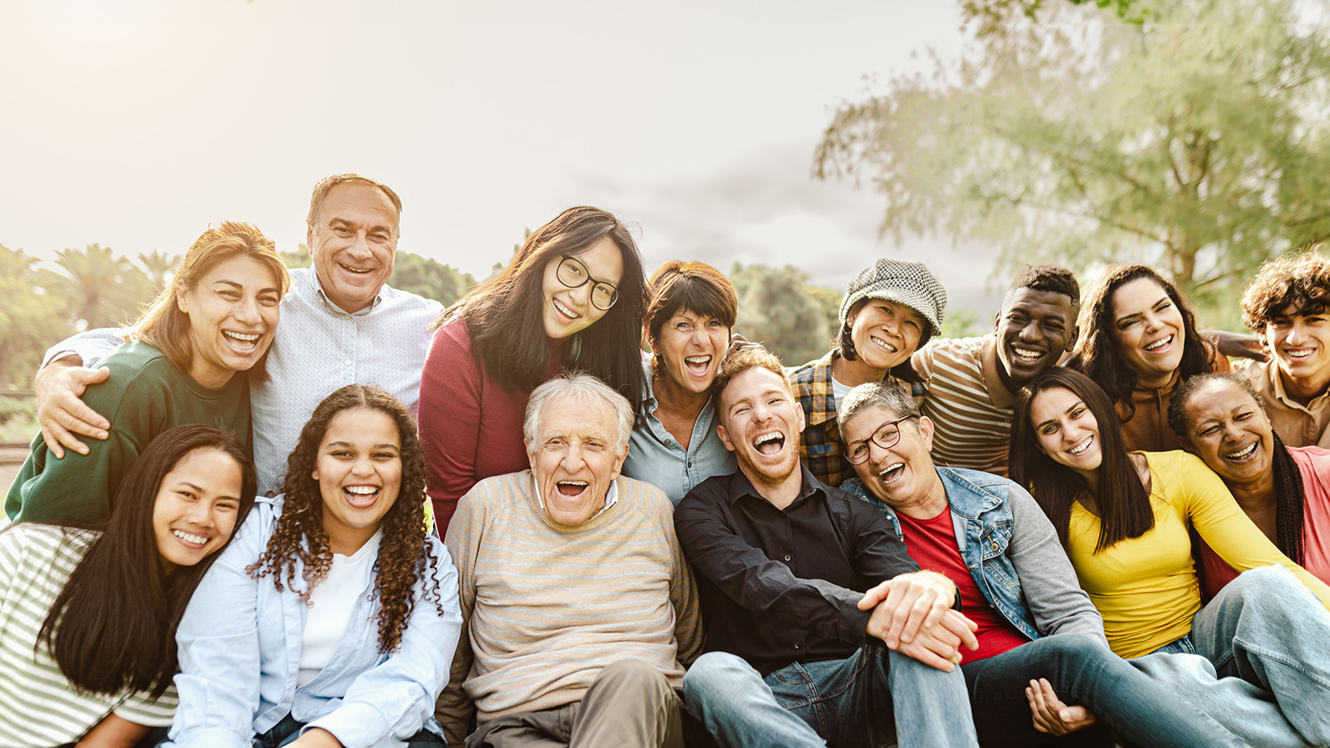 A group of people posing together for a photograph outdoors during daytime.